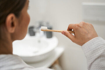 Woman taking care of her oral hygiene - obrazy, fototapety, plakaty