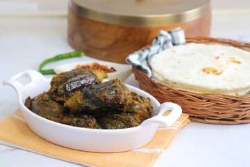 Indian, Maharashtrian side dish or appetizer Bharli Vangi, stuffed Eggplants, Crispy brinjal fry, Aubergine stuffed, served with Rice flour bhakri. copy space