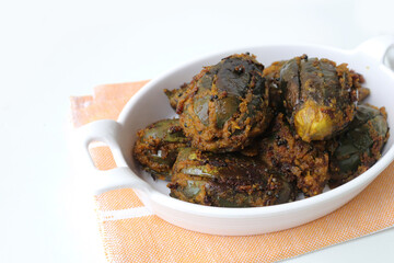 Indian, Maharashtrian side dish or appetizer Bharli Vangi, stuffed Eggplants, Crispy brinjal fry, Aubergine stuffed, served with Rice flour bhakri. copy space