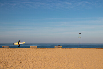 Fototapeta na wymiar Lone surfer at the atlantic coast of Montalivet, France