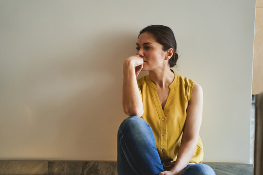 Woman In A Sleeveless Blouse Staring Away