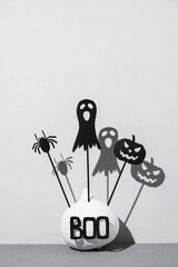 Halloween home decorations. Painted white pumpkin and black scary Halloween shadow puppets on...