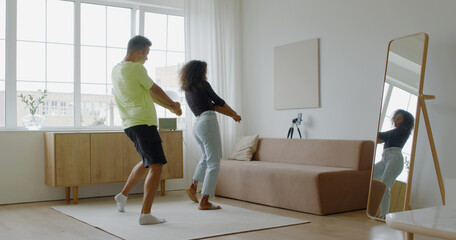 VERTICAL VIDEO POV Interracial couple or friends recording trendy dance moves for social media account