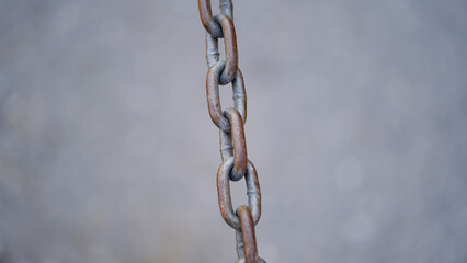 Fototapeta premium Old rusty metal chain on a blurred background
