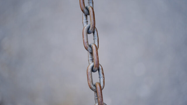
Old rusty metal chain on a blurred background