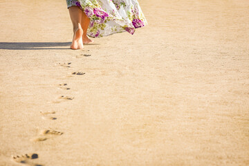 Fototapeta na wymiar A Beautiful foot footprints in the sand killing on nature background