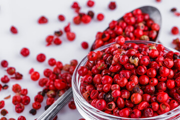 fragrant pink peppercorns on white acrylic background