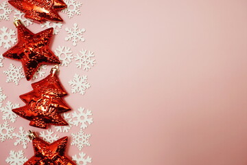 Flat lay composition with Christmas decorations accessories on pink background