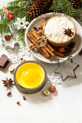 Seasonal baking winter background. Ingredients for Christmas baking - chocolate, spices, nuts, flour and eggs on a stone background. Copy space.