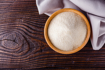 natural organic semolina on dark wooden rustic background