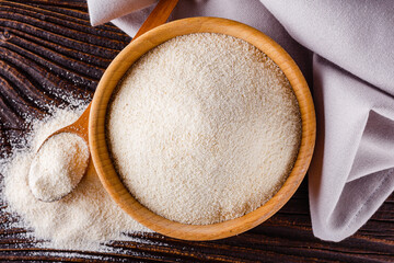 natural organic semolina on dark wooden rustic background