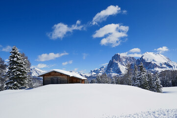 Lonely house in dolomites on a sunny winter day