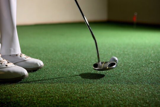 A Man Is Playing Golf At ? Screen Golf Driving Range