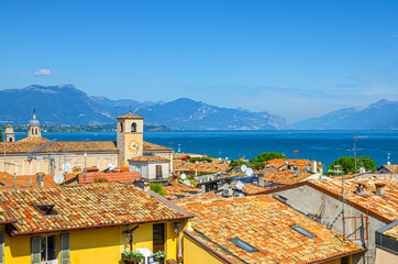 Aerial panoramic view of Desenzano del Garda town with bell tower of Duomo di Santa Maria Maddalena...