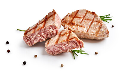 Two grilled tuna steak with rosemary and spices isolated on white. Tuna fish slices with herbs.