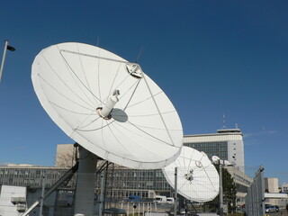 Obraz premium Headquarters of Czech Television - public broadcaster, provider of TV channel for education, culture, fun and information. Large satellite dish in the blue sky.