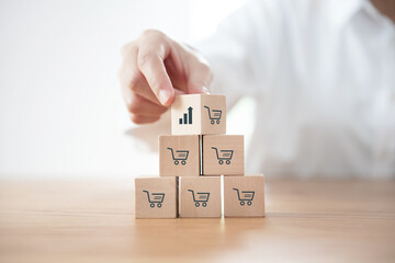 Sale volume increase make business grow, Flips cube with icon growth graph and shopping cart symbol.