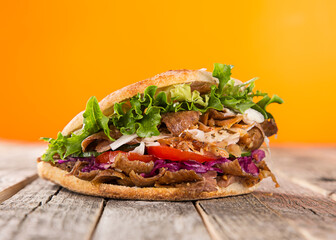 Turkish Doner Kebab Sandwich on wooden background, close-up.