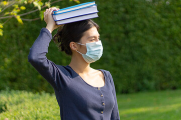 Fototapeta na wymiar Girl student in a protective medical mask.