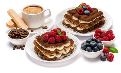 two portions of Classic tiramisu dessert with raspberries and blueberries and cup of fersh hot espreso coffee isolated on white