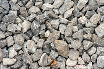 small road stone background, dark gravel pebbles stone texture. Closeup top view gravel. Gravel in garden. Pattern