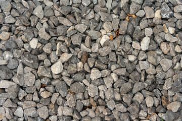 small road stone background, dark gravel pebbles stone texture. Closeup top view gravel. Gravel in garden. Pattern