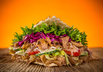 Turkish Doner Kebab Sandwich on wooden background, close-up.