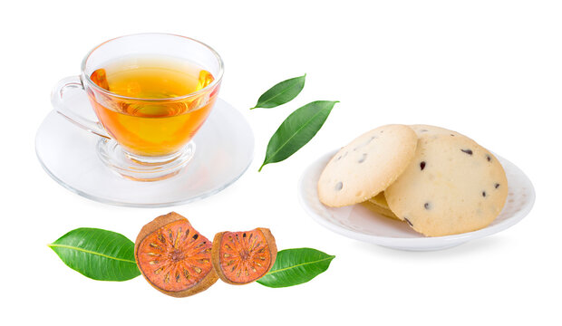 Bael fruit juice or quince tea and dried bael sliced fruit and cookie isolated on white background
