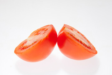 Red tomato vegetable with cut isolated on white background. Two halves of a tomato