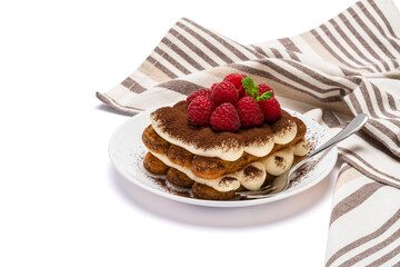 portion of Classic tiramisu dessert with raspberries on ceramic plate isolated on white background with clipping path