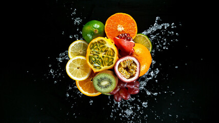 Fototapeta na wymiar Freeze Motion Shot of Fresh Fruits with Splashing Water Isolated on Black Background.