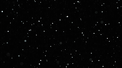 Falling snow on black background, close-up.