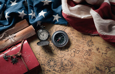 Happy Columbus Day concept. Vintage American flag with compass and retro treasure manuscript.  Flat lay, top view with copy space. - obrazy, fototapety, plakaty