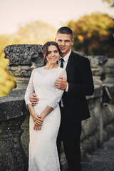 Handsome groom and his cute bride on the old balcony. wedding photography
