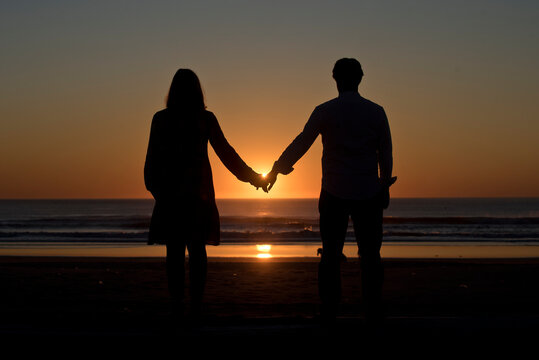 Expecting couple at sunset