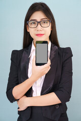 Fototapeta premium Young women in suit holding her smartphone