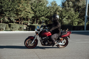 Man rides a motorcycle in the city.Motorcyclist riding a bike during the day on the road