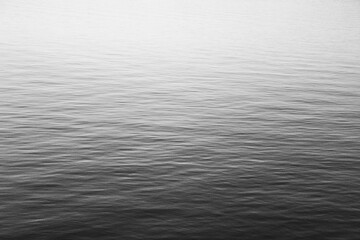 Close-up of water texture, smooth waves of water on the shore, landscape photo of water 