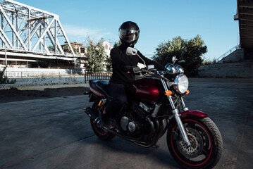 Man seat on the motorcycle.Motorcyclist in black helmet on a red bike