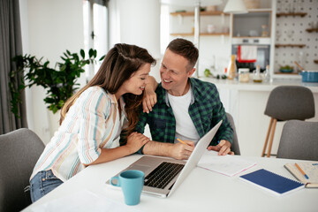 Husband and wife preparing bills to pay. Young couple having financial problems...