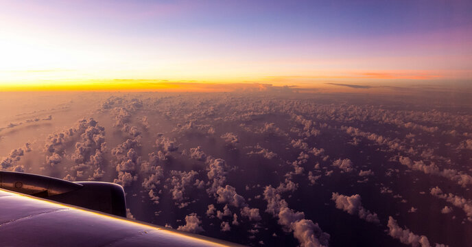 Dusk Views Of Scattered Clouds Over The South Pacific Ocean On A Long Haul Flight  .