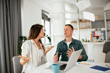 Fototapeta premium Husband and wife preparing bills to pay. Young couple having financial problems...