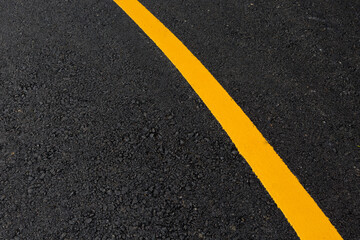 Yellow line on asphalt road texture background