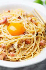 Italian pasta carbonara made with egg, hard cheese, cured pork guanciale or pancetta and black pepper