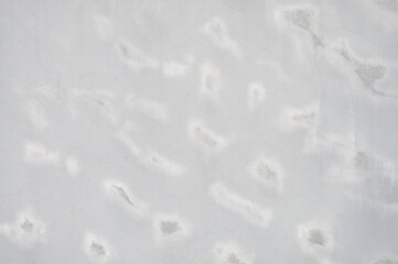 The texture of the gray cement wall is different.