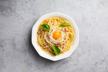 Italian pasta carbonara on a concrete gray background