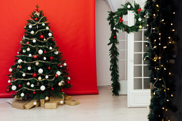 Beautiful Christmas living room with decorated Christmas tree, gifts and fireplace. The idea for postcards