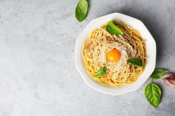 Italian pasta carbonara on a concrete gray background with copy space