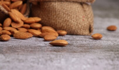 Almonds in bag isolated on grey background