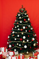 Beautiful Christmas living room with decorated Christmas tree, gifts and fireplace. The idea for postcards